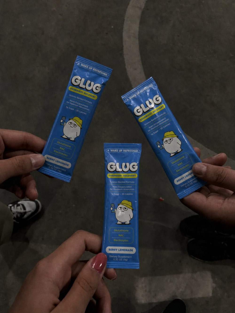 Friends holding Glug Berry Lemonade sticks